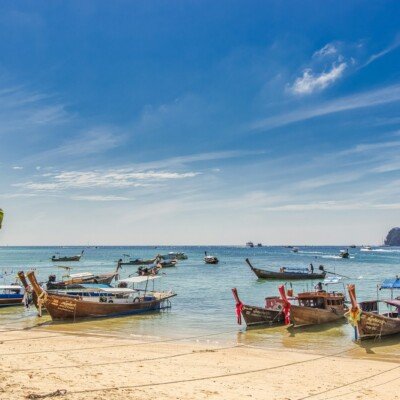 white and brown boat on sea shore during daytime