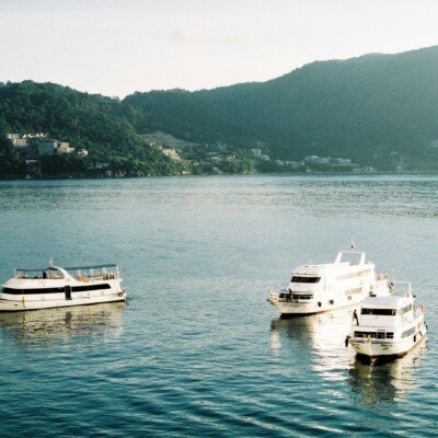 white and black boat on body of water during daytime