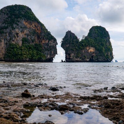 a group of rocks sitting on top of a beach