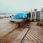 white and blue passenger plane on concrete ground