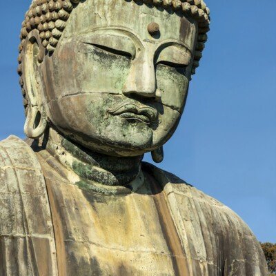 a large statue of a person with eyes closed